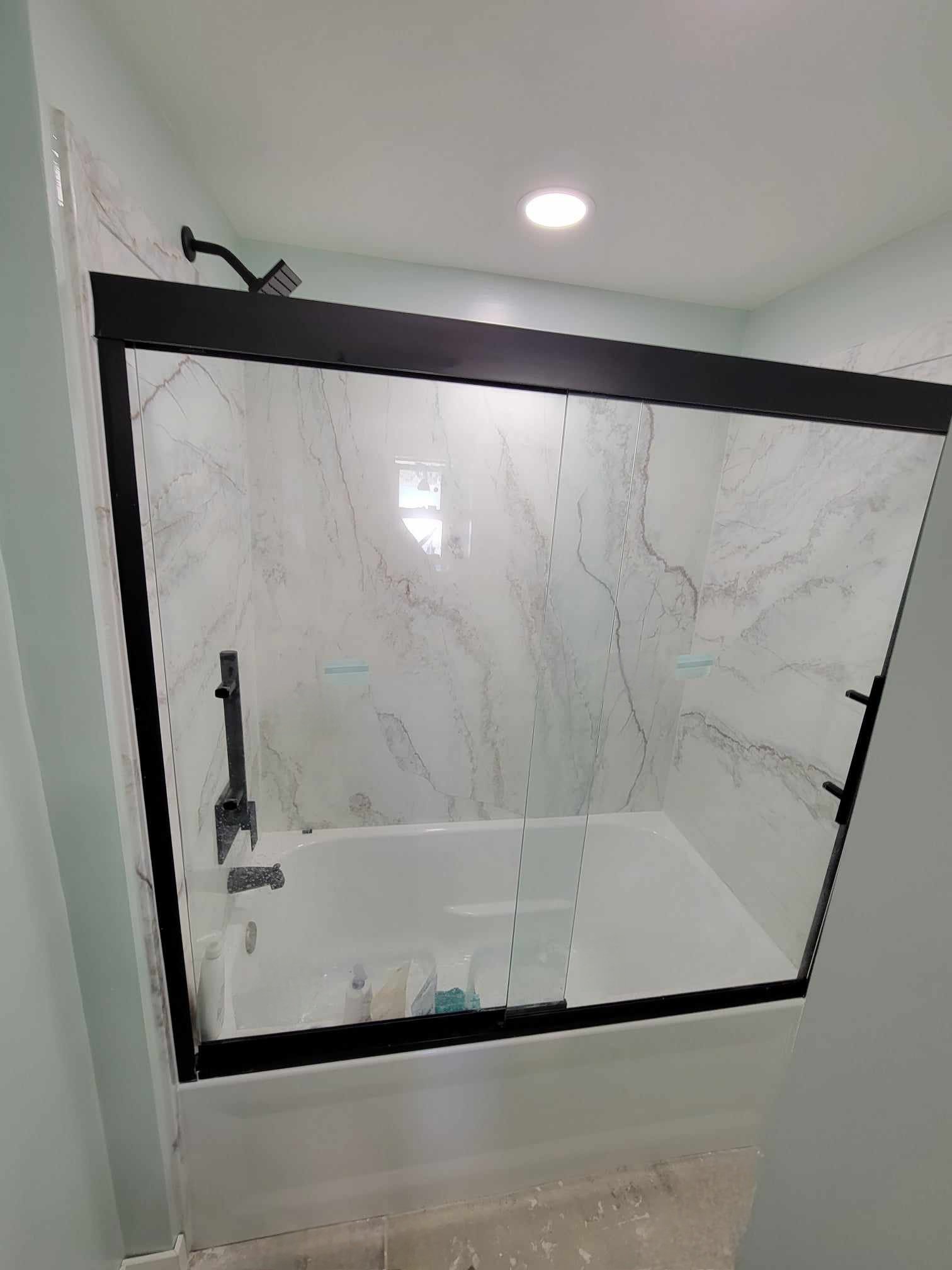 Beautiful shower surround selected with an amazing matte black shower trim kit and shower door.