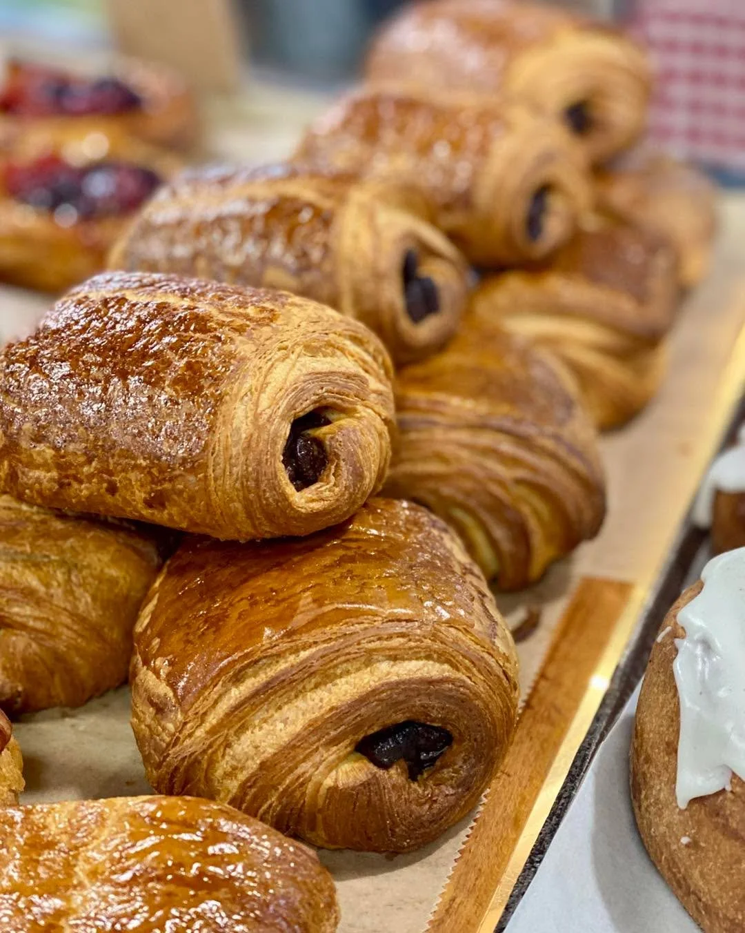 Bakery case full of delicious pastries today! We have chocolate croissants, Fruit Danish (and a new flavor: Peach Blackberry) and Raspberry Dark Chocolate Muffins.
