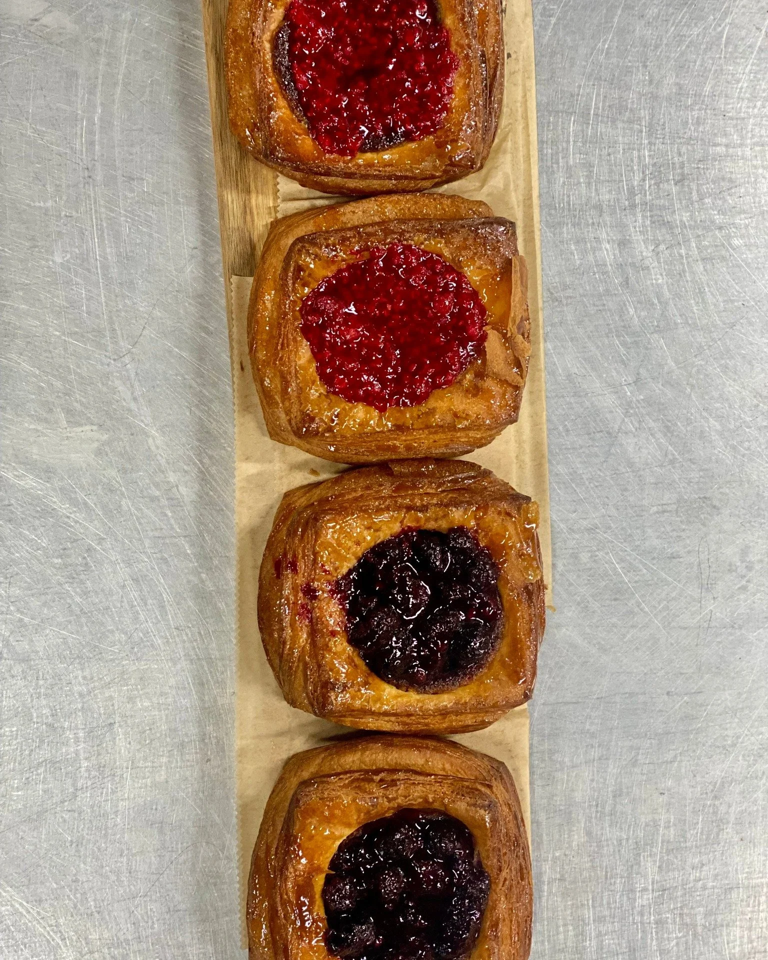 A bakery case full of goodies! We have Fruit Danish, Cream Filled Croissants, Muffins, and much, much more!
