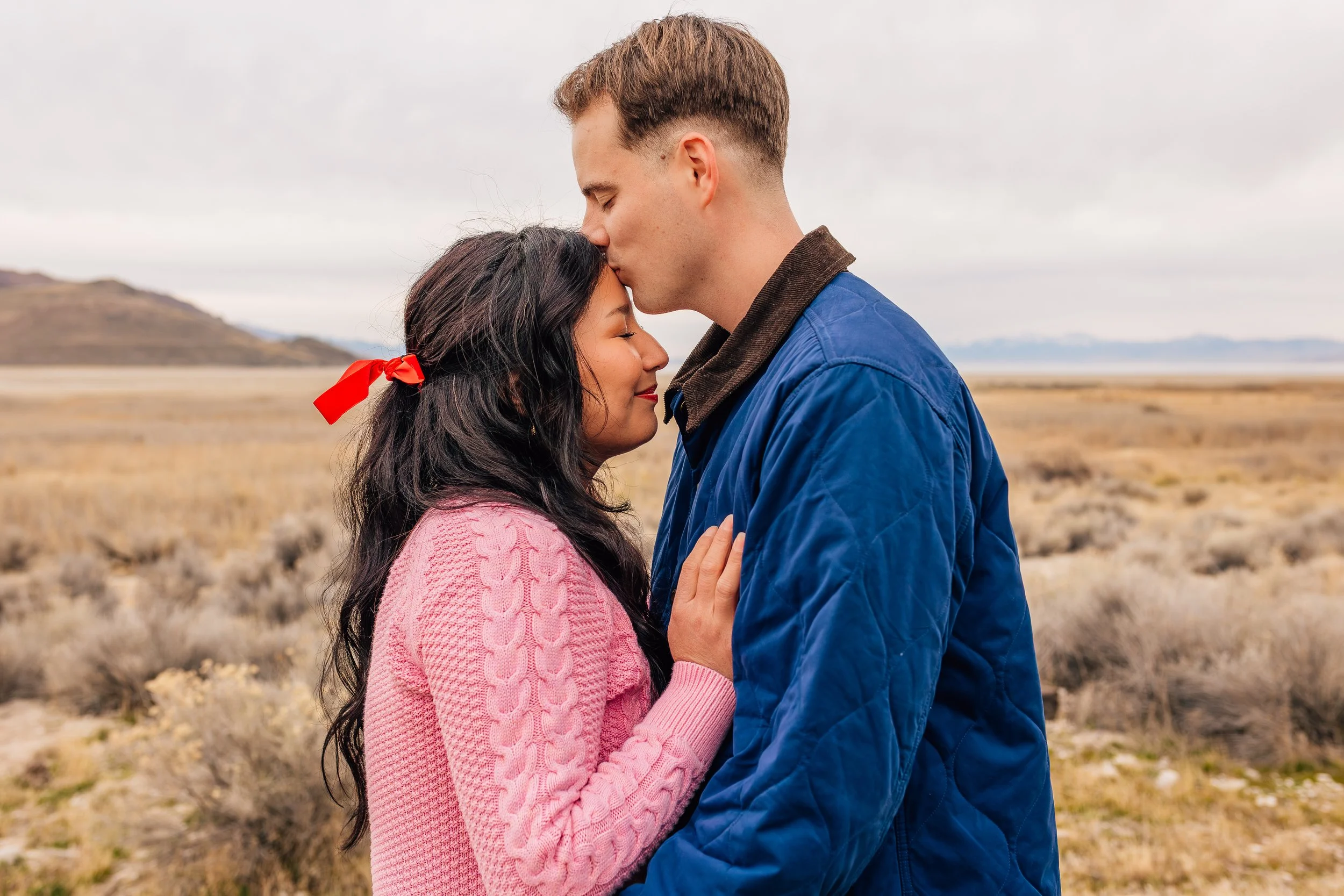 Couple embracing during a winter couples photography session at Antelope Island in Utah