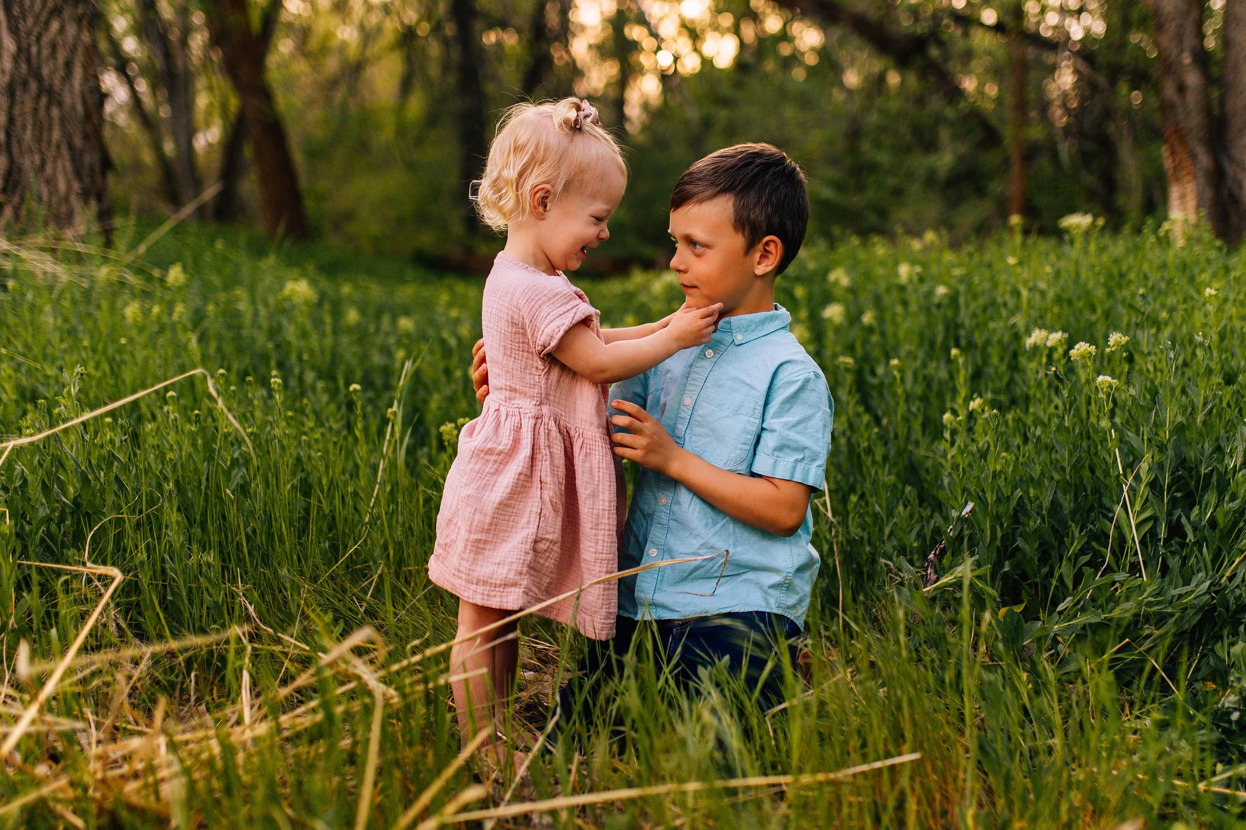 Unposed moment between siblings during a Northern Utah documentary family photography session in natural outdoor light.