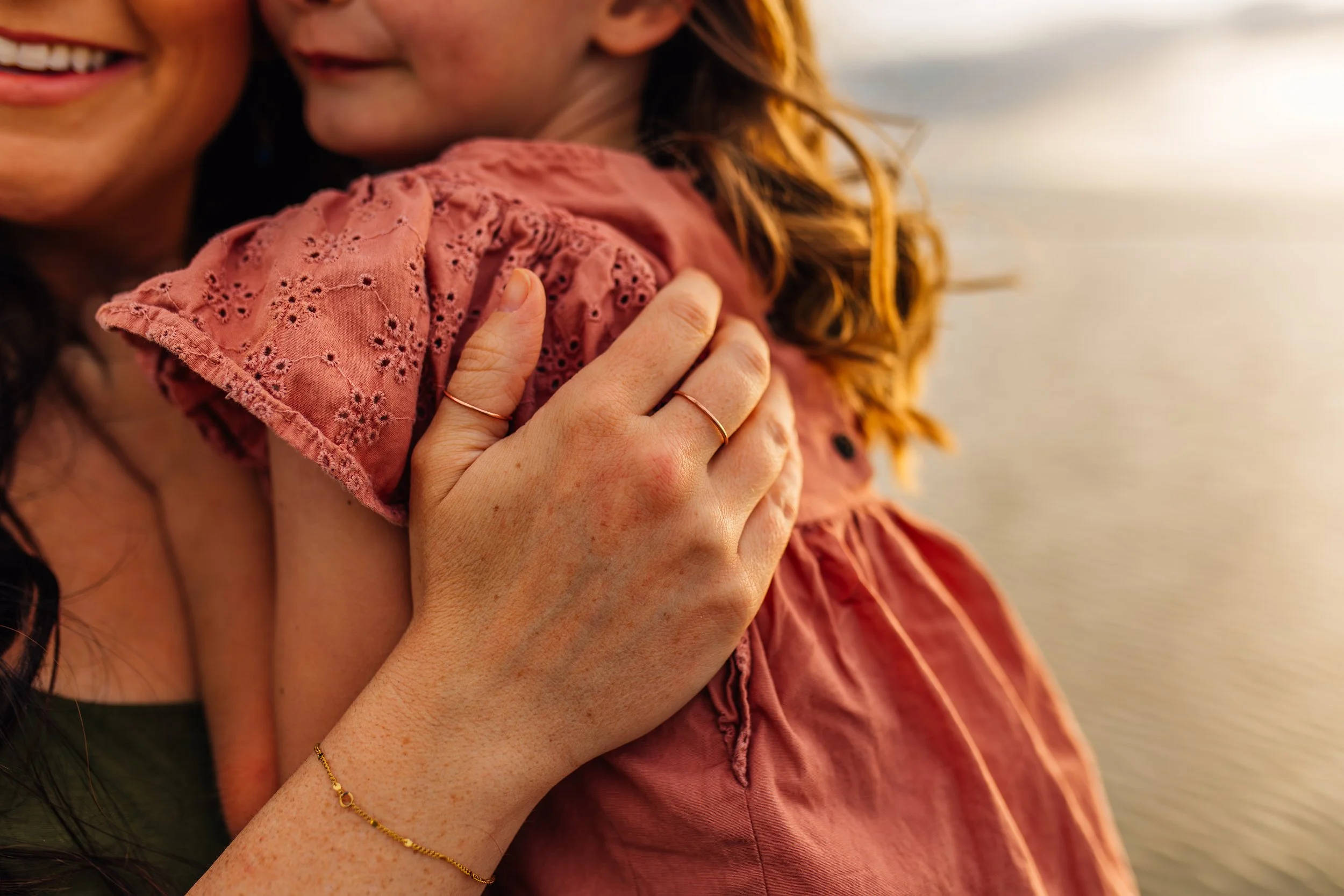 Close-up documentary family photograph of a mother holding her child during a natural light session in Utah