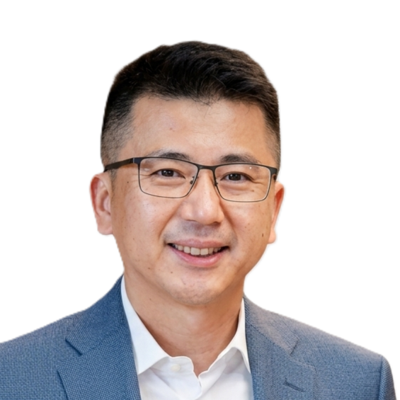 Headshot of a smiling man wearing glasses, a white shirt, and a blue blazer against a light background.