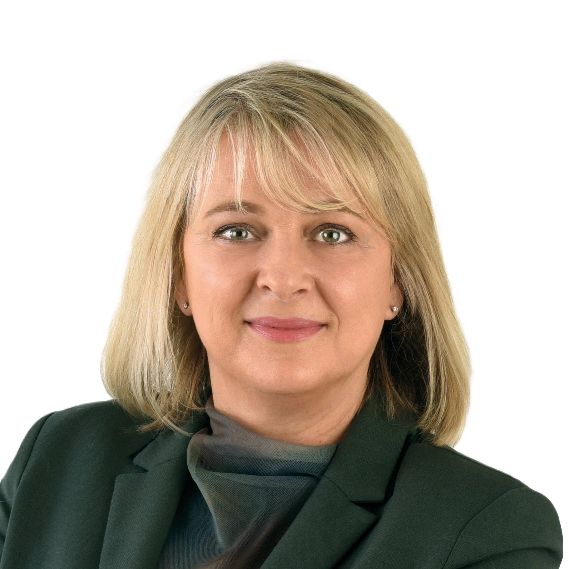 Close-up of a middle-aged woman with shoulder-length blonde hair, green eyes, and hoop earrings, wearing a dark blazer and gray turtleneck, smiling softly against a white background.