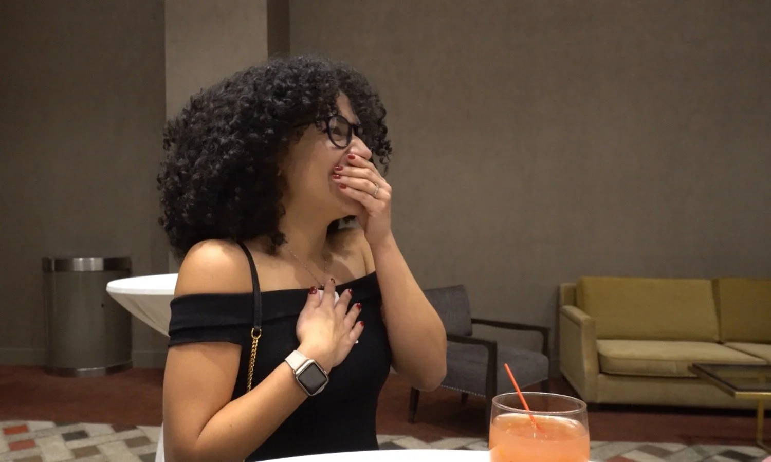 A guest reacts in amazement to close-up mentalism during a cocktail hour