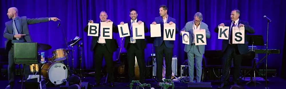 Audience volunteers holding letter cards on stage during mentalist Fred Berthelot's show