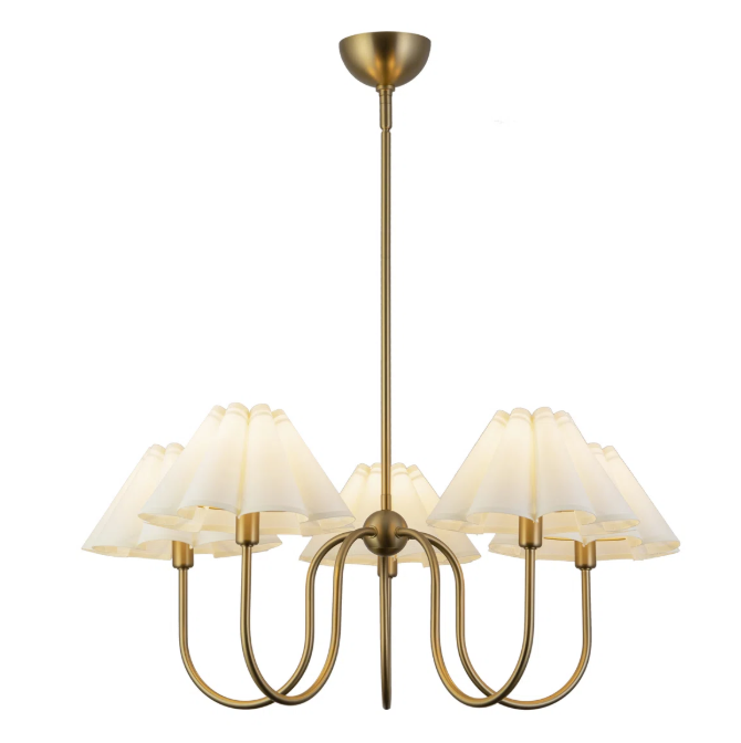 Chandelier with a gold finish and five light fixtures, each with a white lampshade, hanging from a ceiling