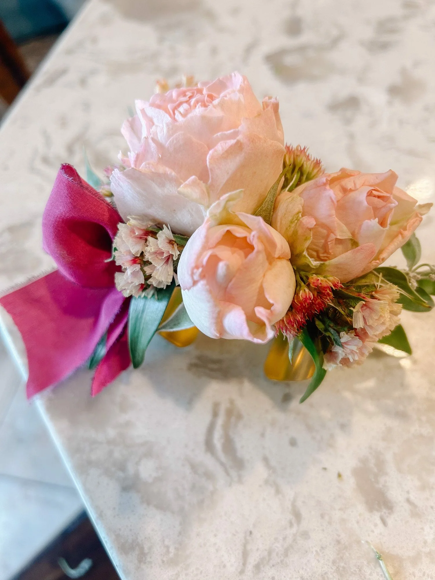 pink wrist corsage for school dance with pink ribbon