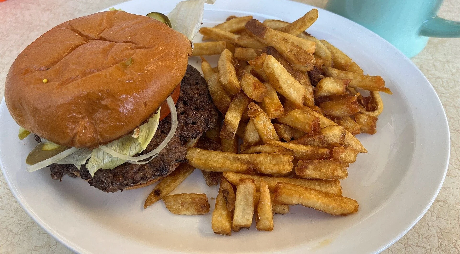 Paradise Eats burger with fries