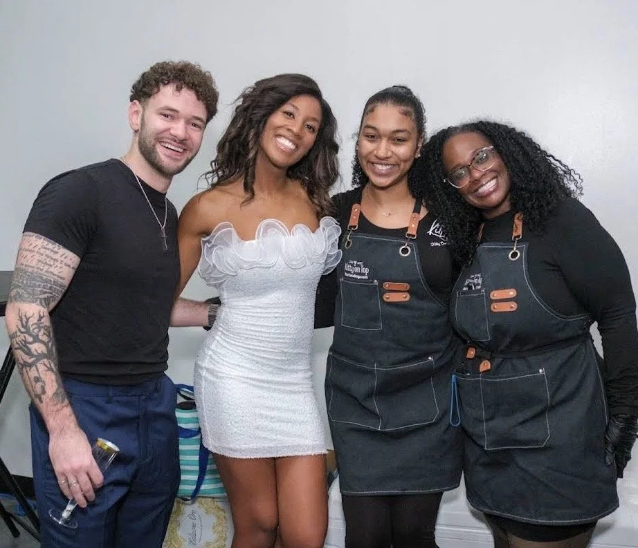 photo of a cocktail in a champaign glass with petals on the outside of the glass.