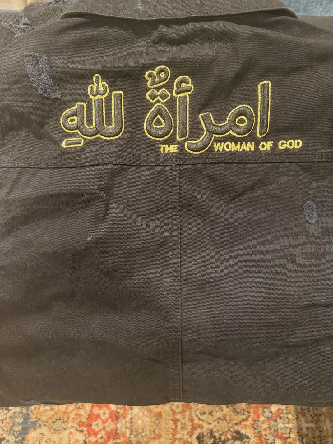 Close view back of black jean jacket.jpg