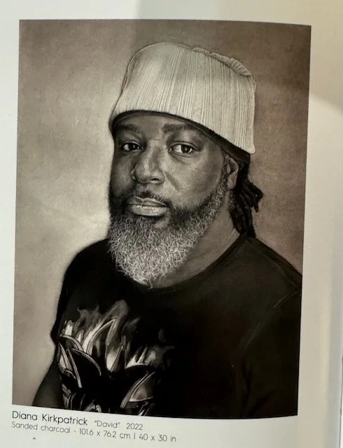Charcoal portrait of a man with a beard and wearing a knit cap, created by Diana Kirkpatrick. Titled "David," 2022.