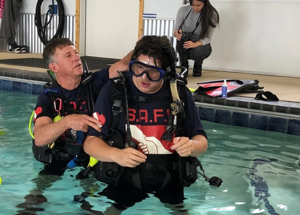 Dale helping a student with is mask strap