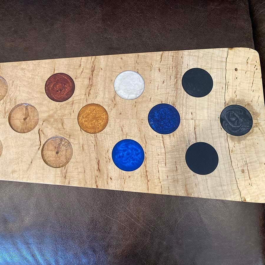 Epoxy Color Sample Board

In preparation for my biggest project up to that point, I took a scrap piece of the wood and tested epoxy colors to see how they looked in combination with the wood.  I made extra holes for future colors and can keep the boa