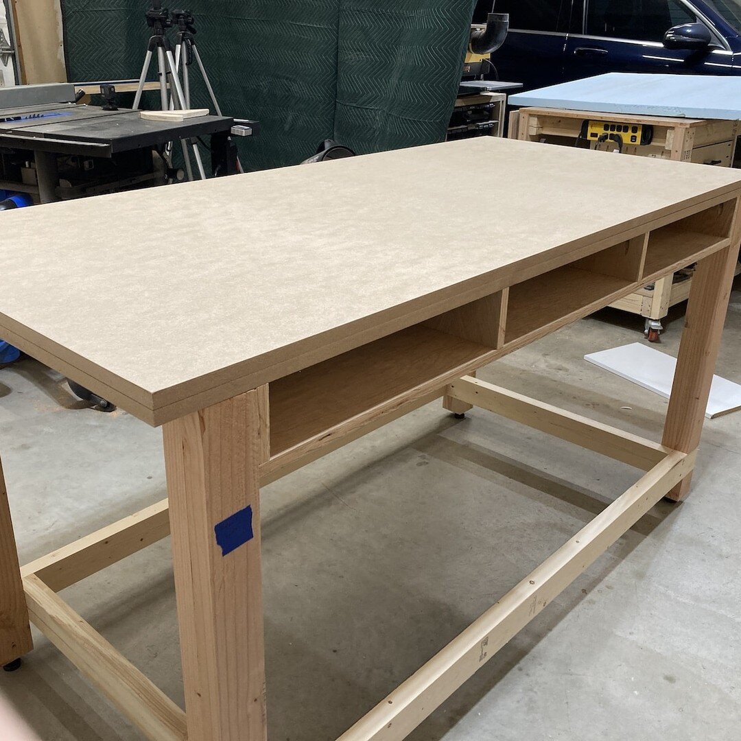 New Workbench/Assembly Table (Part 3 of 3)

Workbench build photos part 2 - Attached the worktop to the base. Added Red Oak edge banding along the edges of the MDF top. Routed the Dados for the T-Track and finished the top with Shellac before install