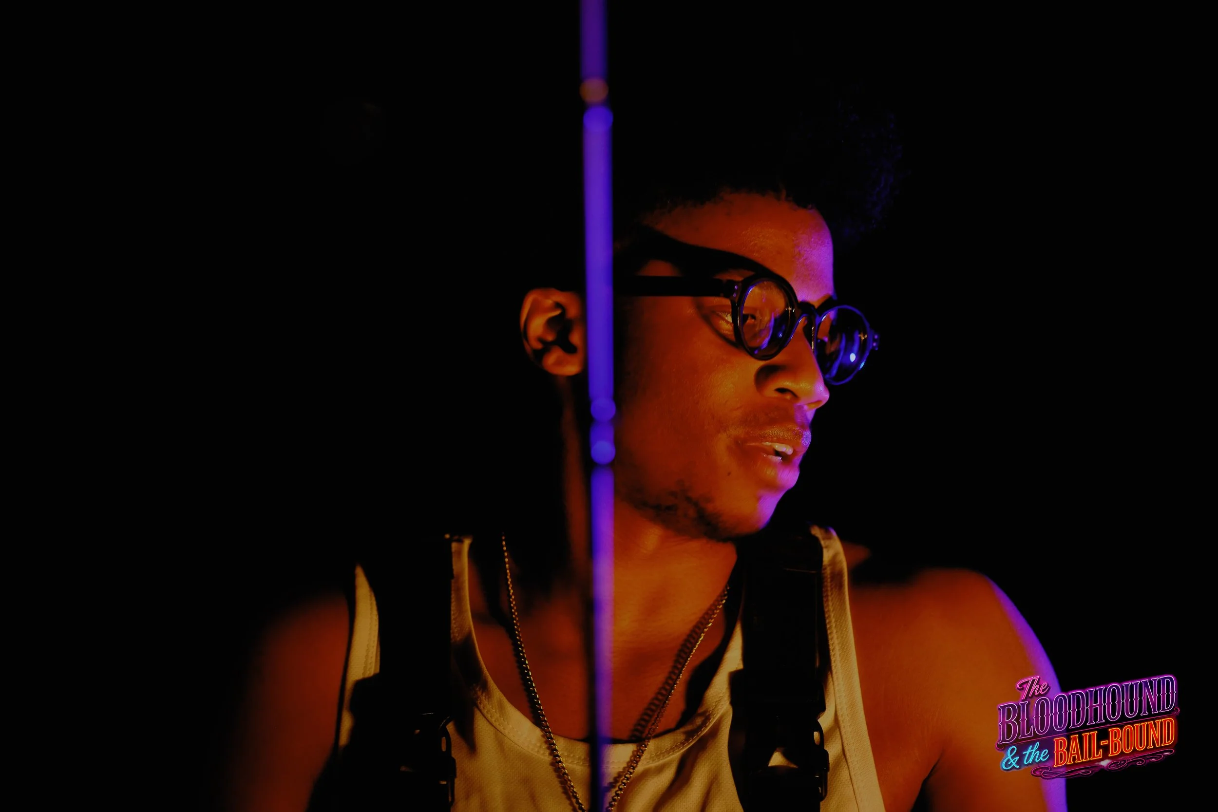 A frame from the original streaming TV series THE BLOODHOUND & THE BAIL-BOUND (2026) by Filmmaker Lazarus X.  © 2027 The Lazarus X Archives for Media, Rights & Masters LLC. All Rights Reserved.