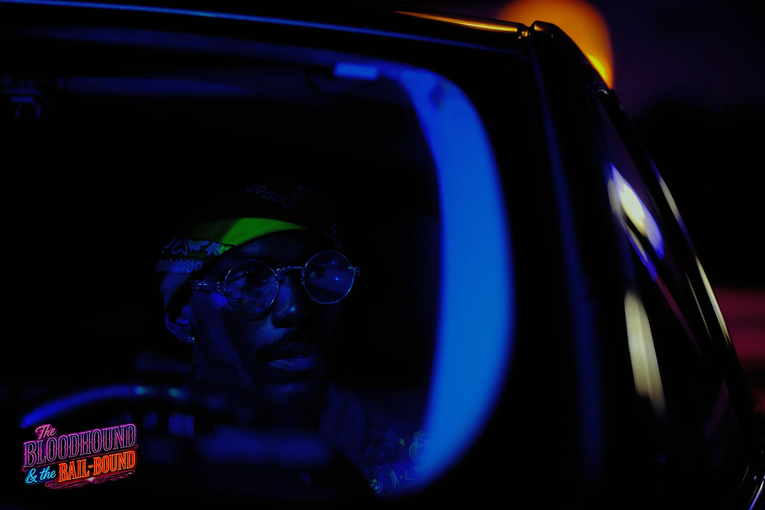 A frame from the original streaming TV series THE BLOODHOUND & THE BAIL-BOUND (2026) by Filmmaker Lazarus X.  © 2027 The Lazarus X Archives for Media, Rights & Masters LLC. All Rights Reserved.