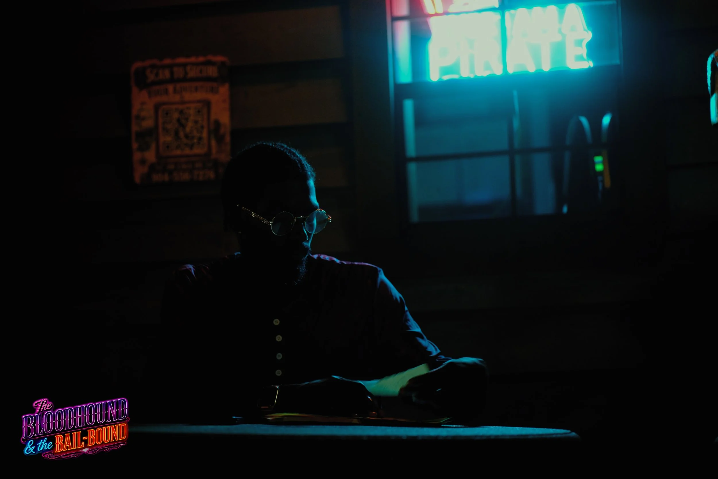 A frame from the original streaming TV series THE BLOODHOUND & THE BAIL-BOUND (2026) by Filmmaker Lazarus X.  © 2027 The Lazarus X Archives for Media, Rights & Masters LLC. All Rights Reserved.