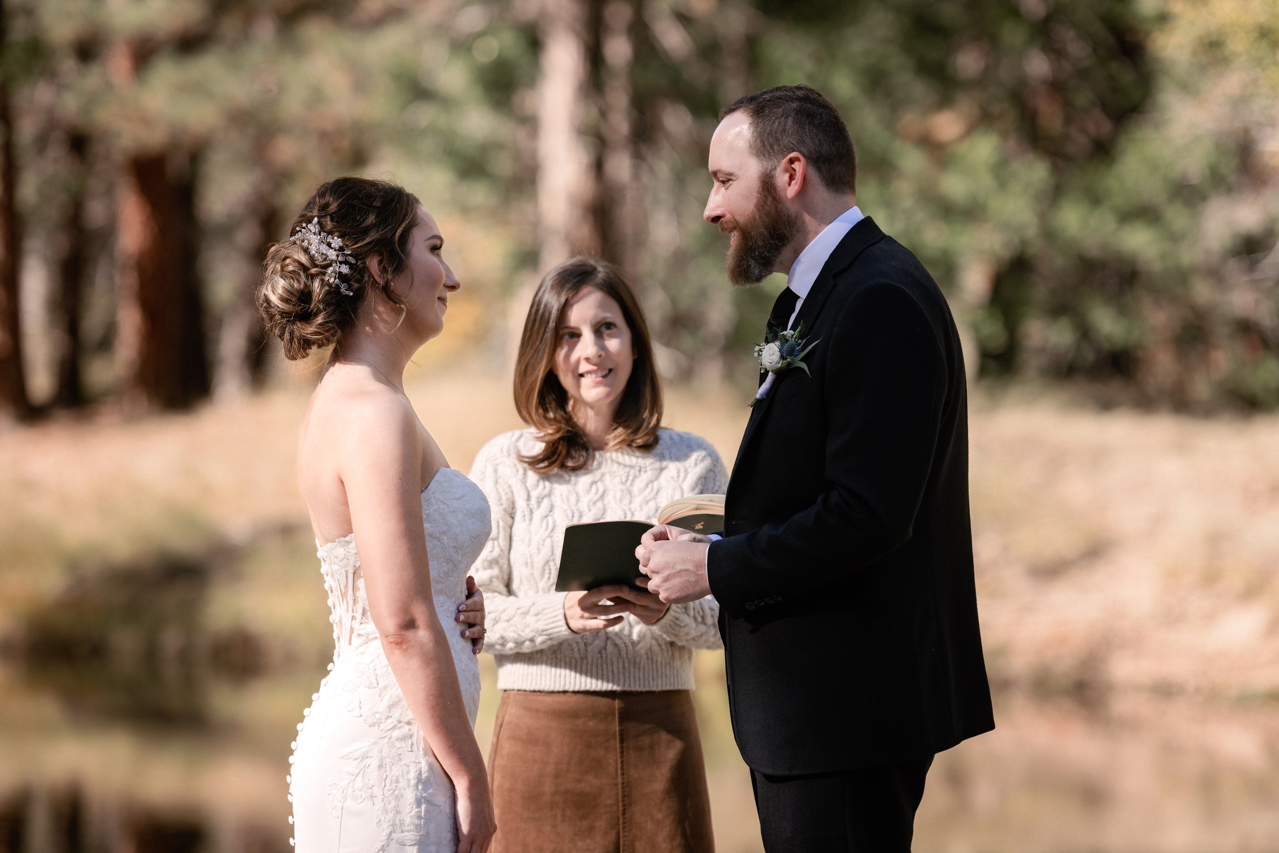 Couple saying their vows with their close friend officiating in Yosemite