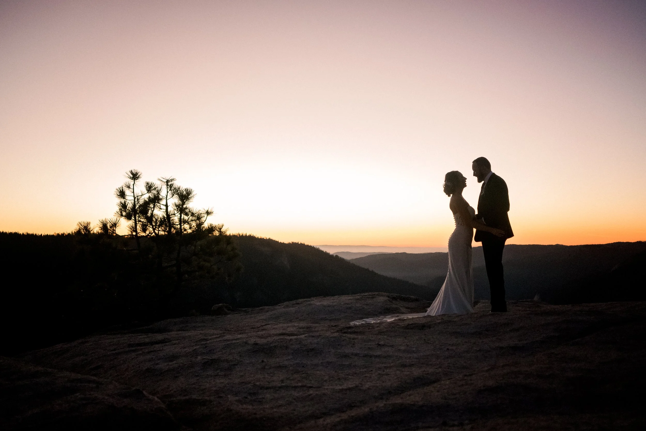 Bride and groom on top of Taft Point in Yosemite
