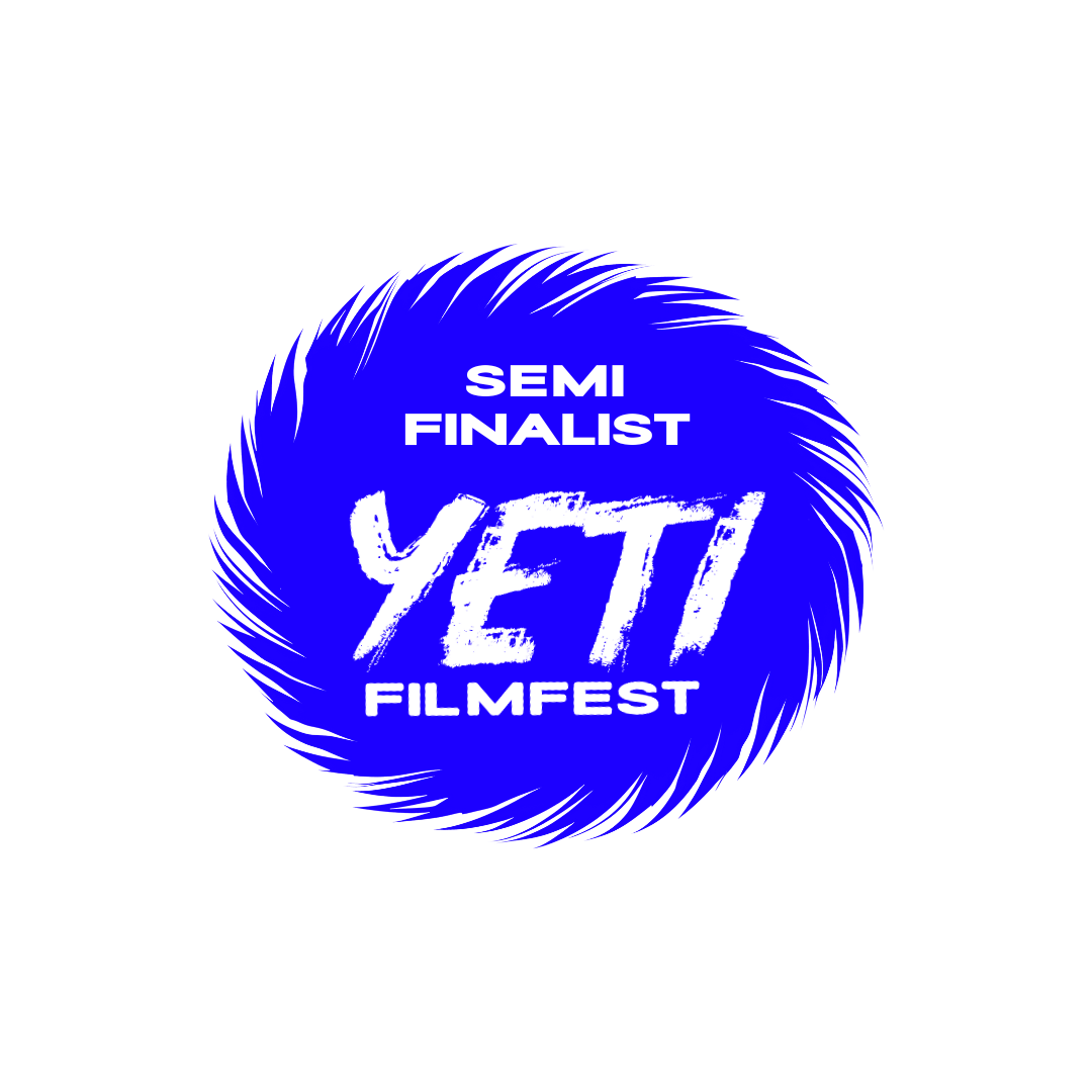 Blue circular logo with white text that reads 'Semi Finalist', 'Yeti', and 'Filmfest' on a black background.