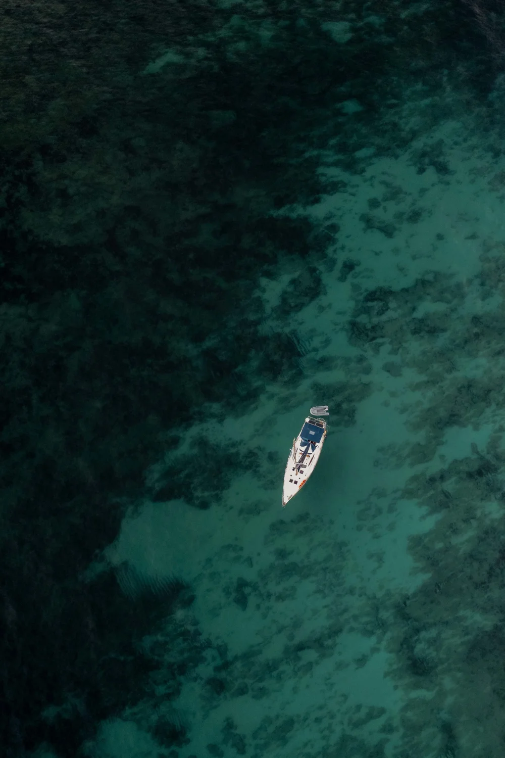 Türkisfarbenes Meer mit Boot, Luftaufnahme auf Mallorca