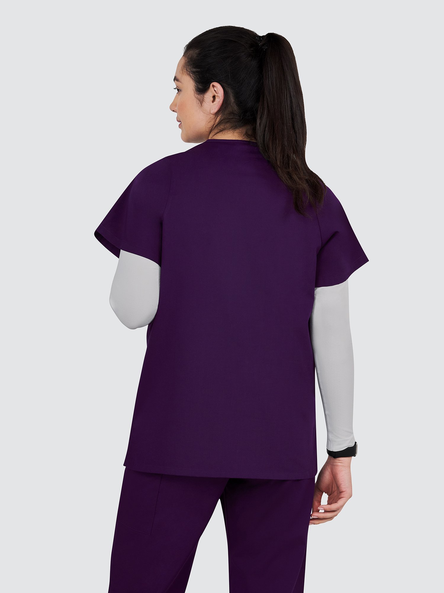 pants pocket and is wearing a smartwatch.