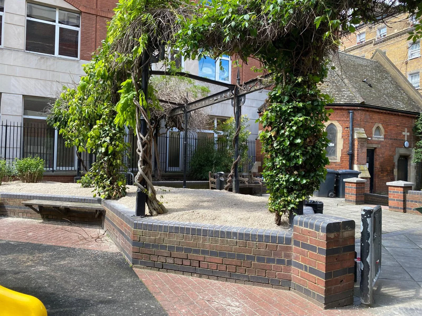 The existing pergola’s overgrown ceiling’s cut out to allow light to reach the planters below