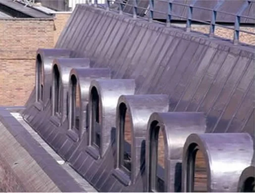 Close-up of a rooftop with metal ventilation pipes embedded in the roof