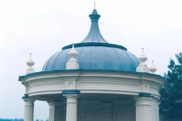 A blue domed pavilion with white decorative accents and supporting columns.