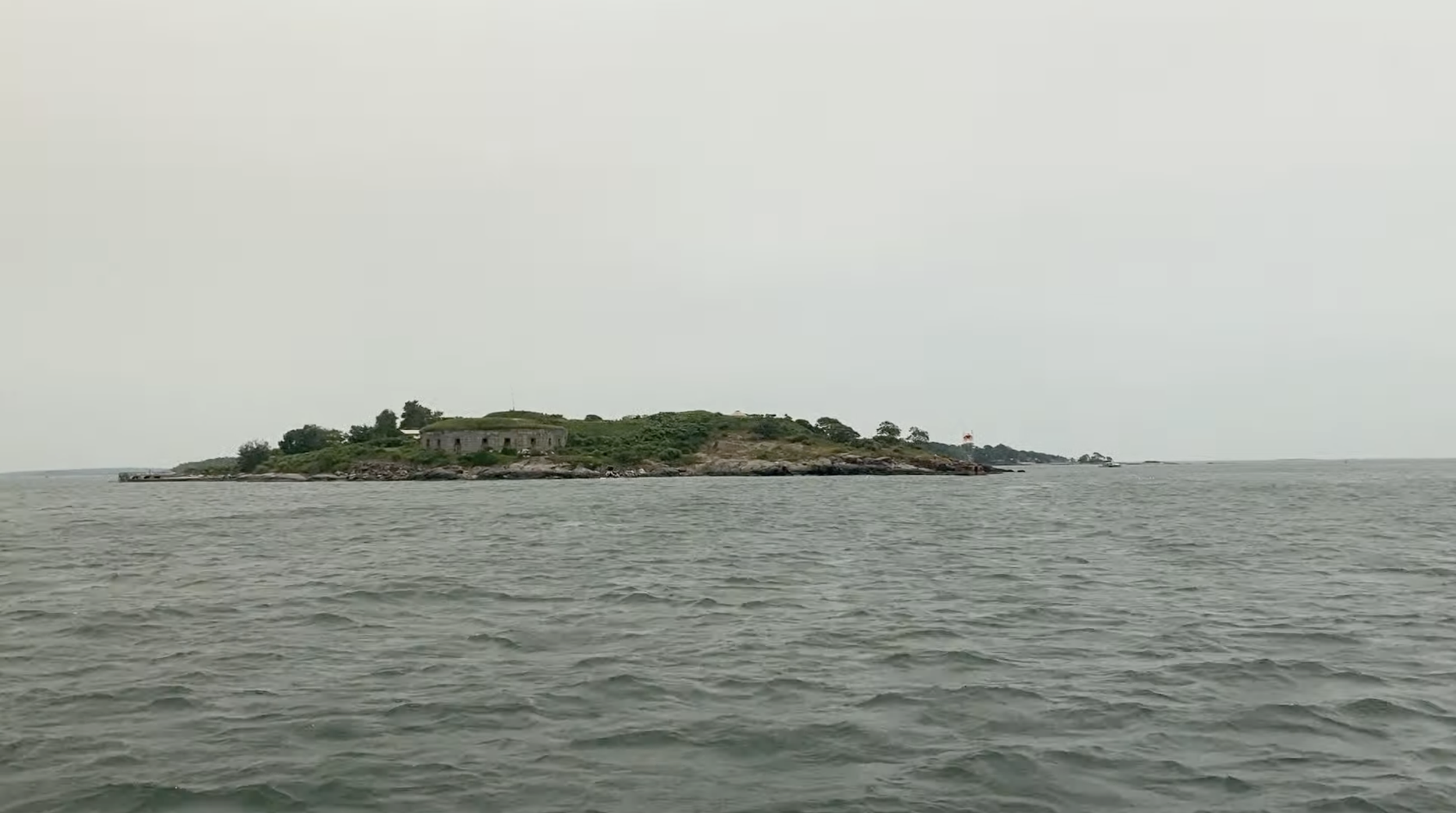 An island with one large building and some trees