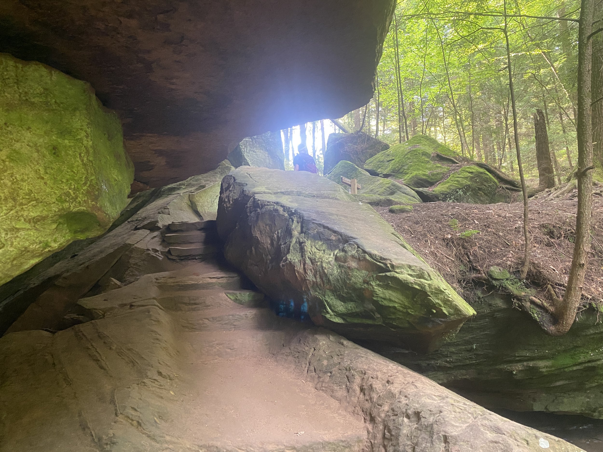 A walkway carved through stone, with stone overtop of the walkway