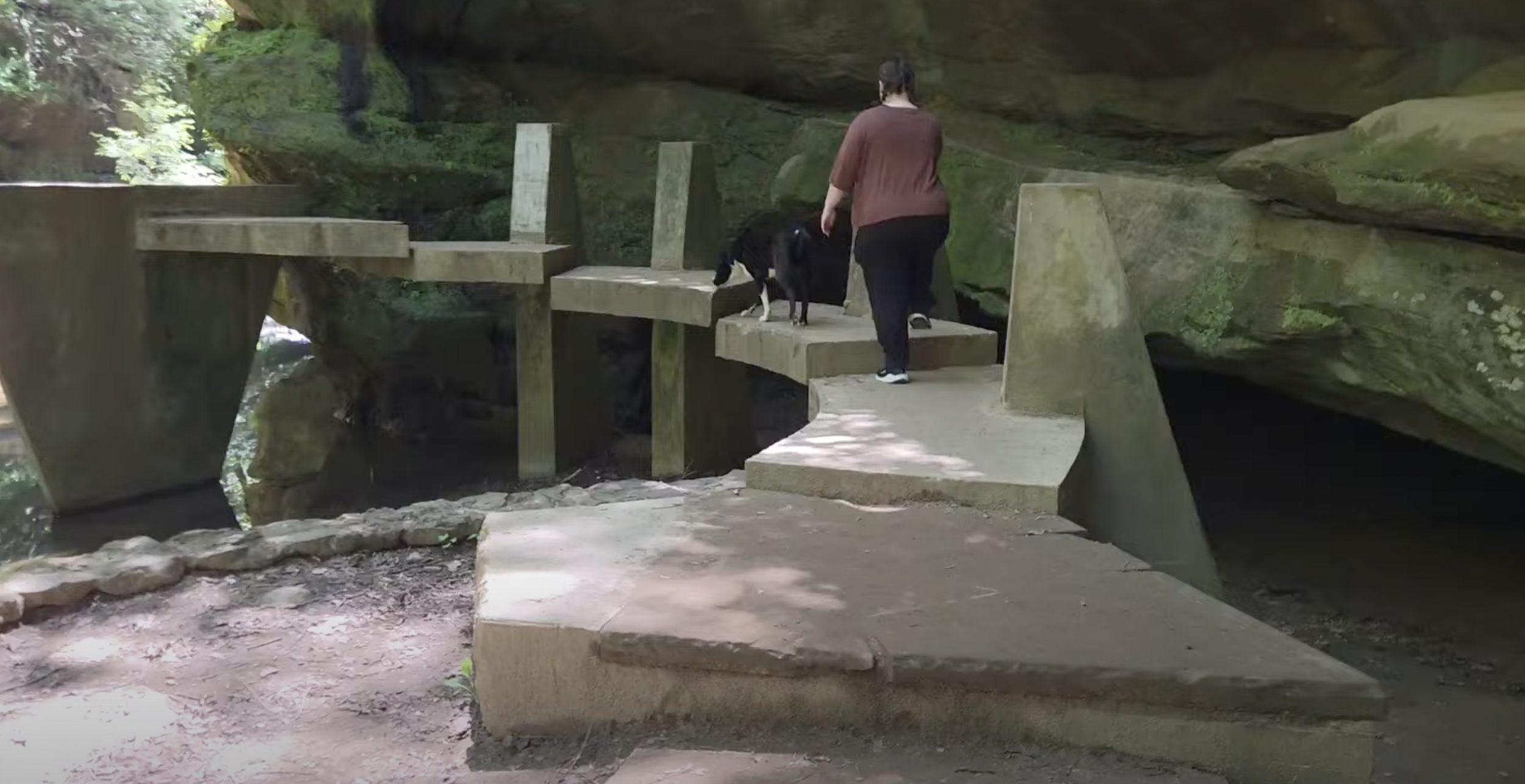 A man made staircase leading over the water on a hiking path