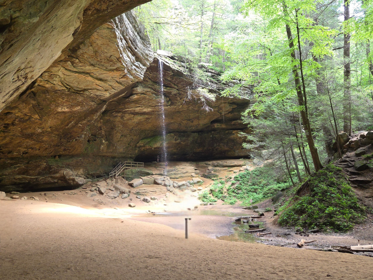 A small waterfall surrounded by a horseshoe shaped cliff