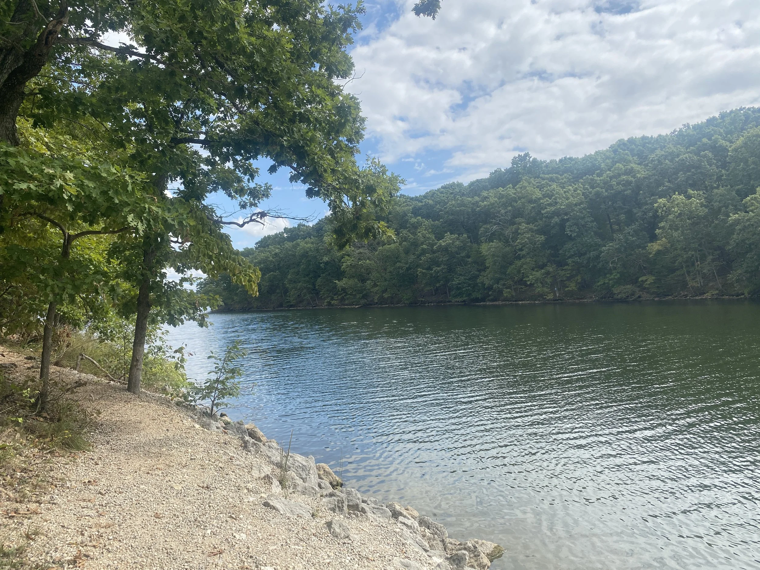A lake with trees on either side of the water.