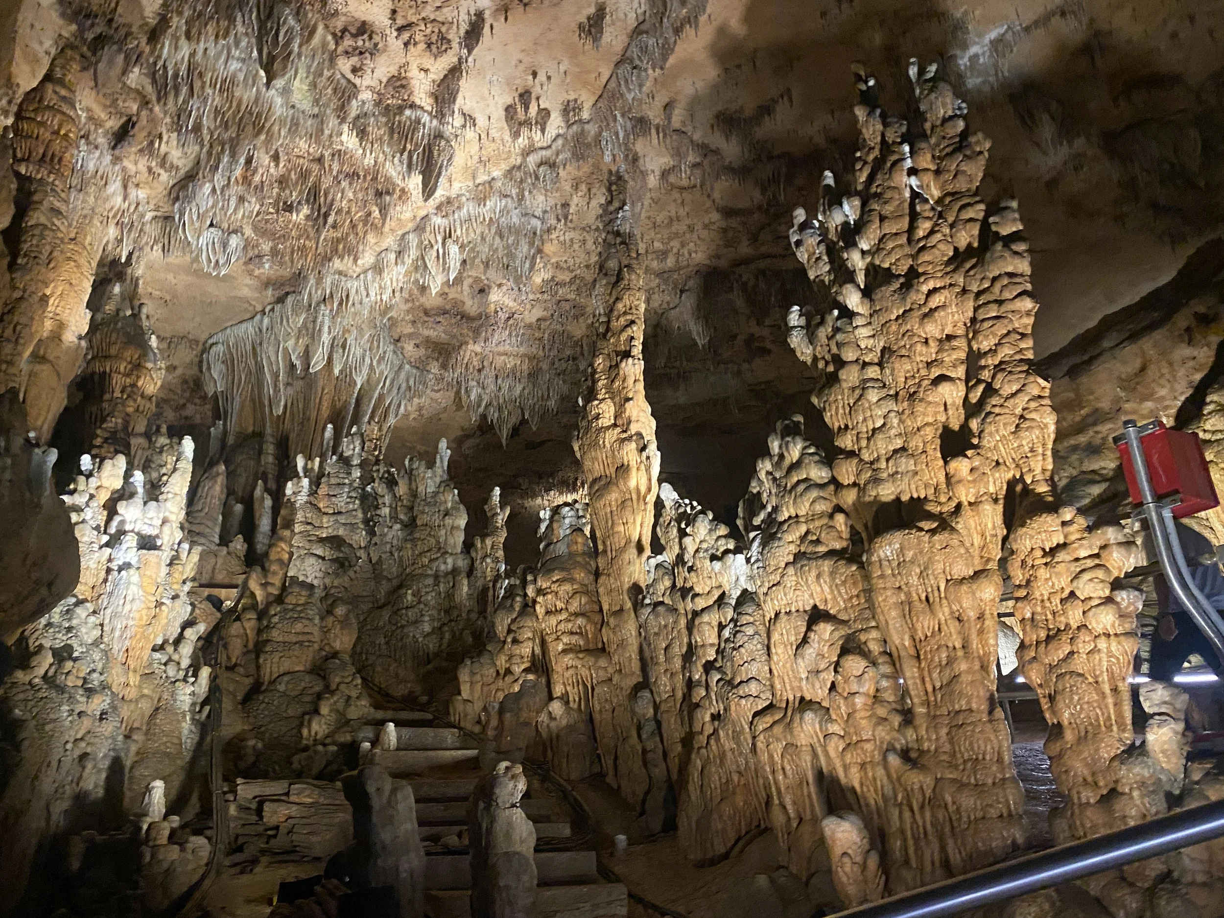 A large rock formation in a cave including stalagmites.