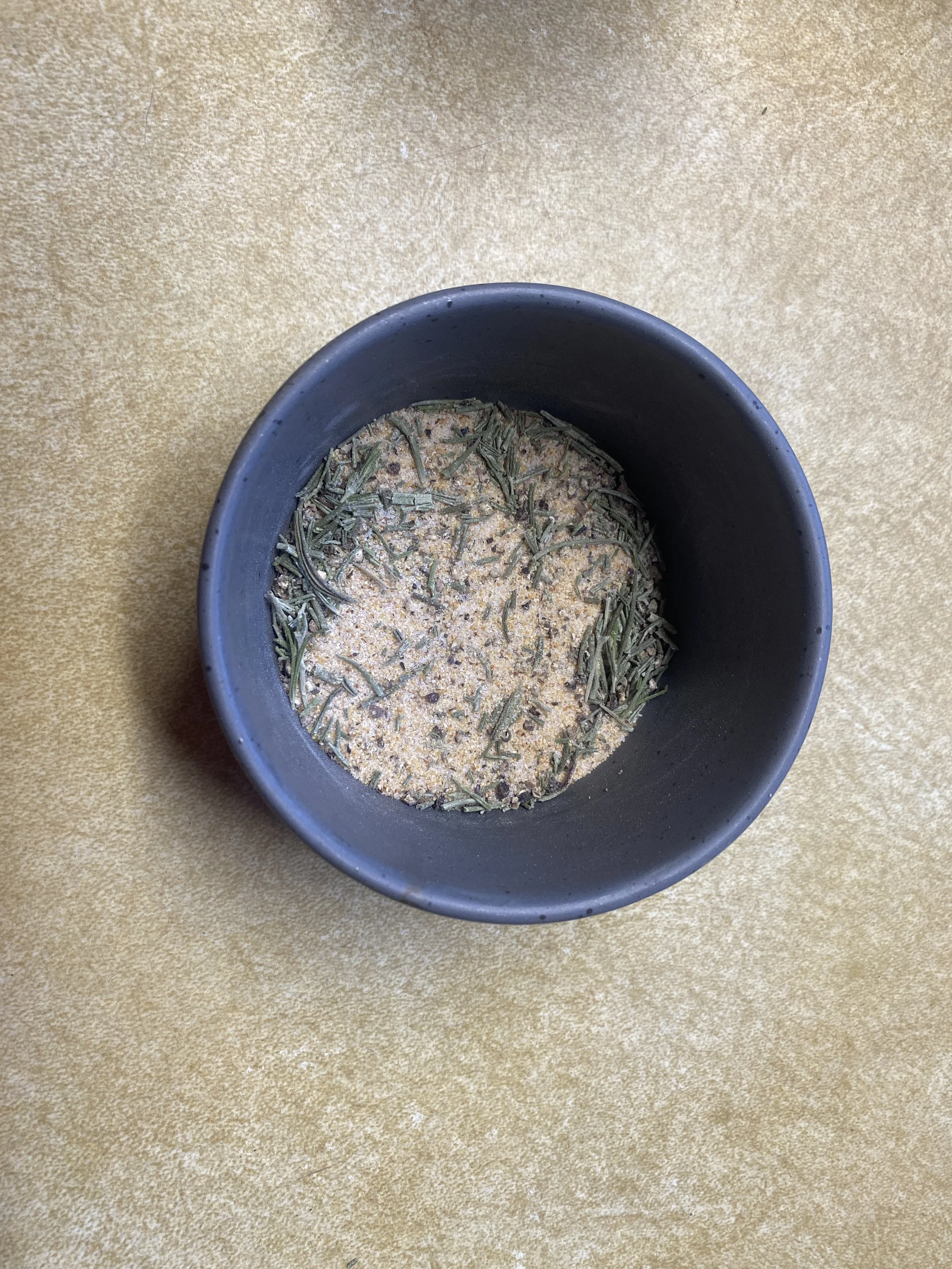 Ramekin with garlic rosemary seasoning blend.