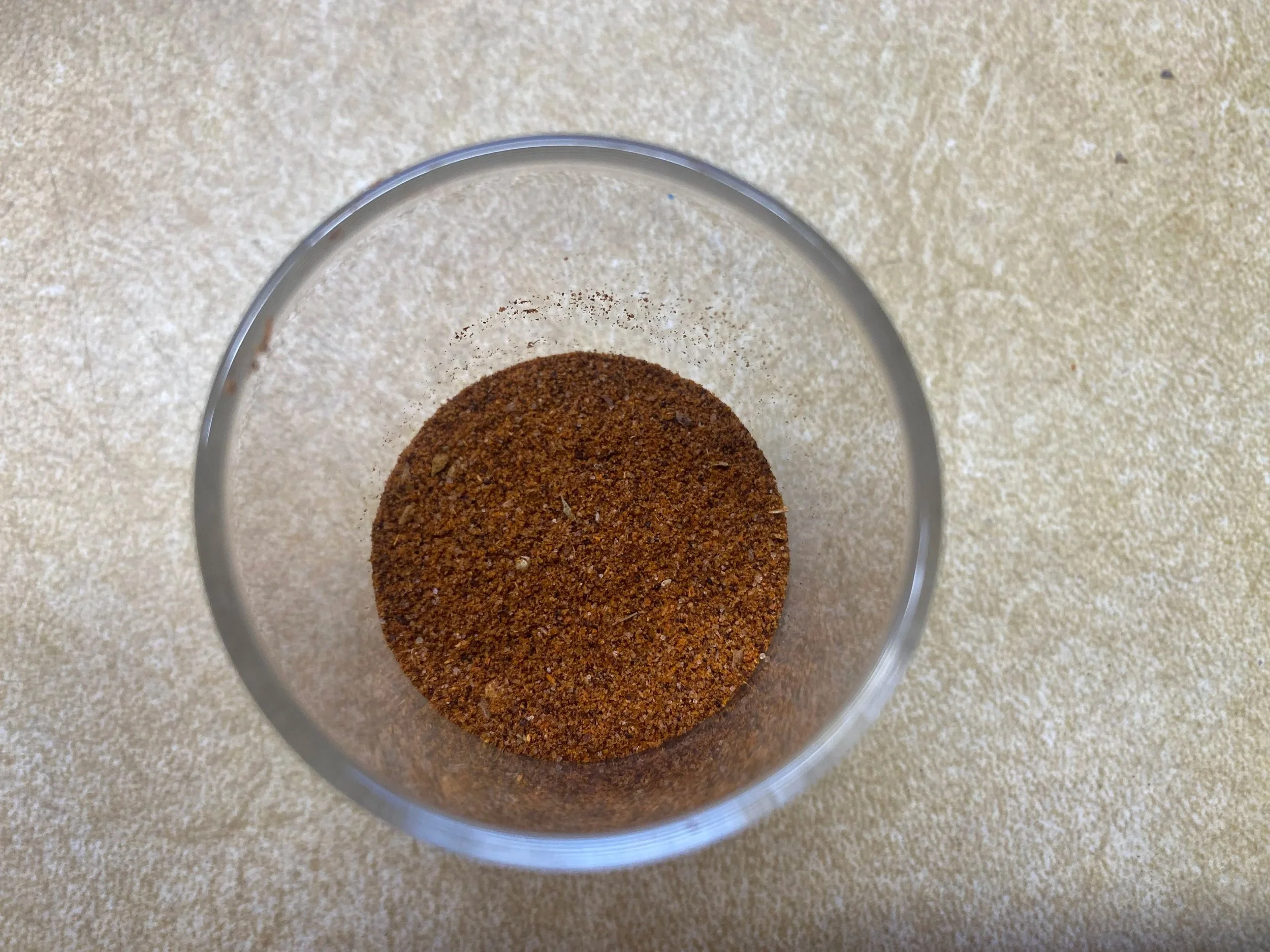 Taco seasoning in a glass jar.