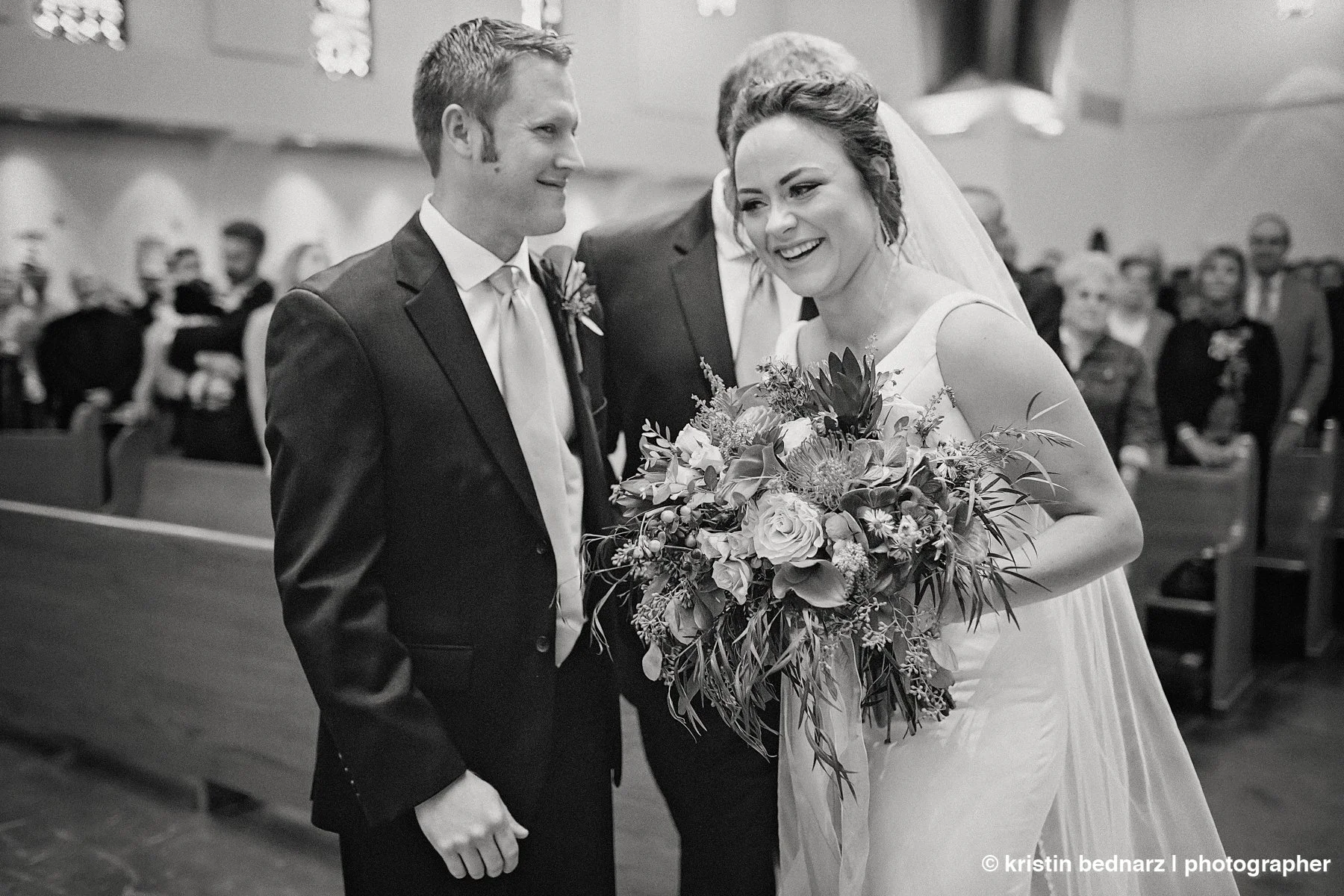  and from this point on the fun began!  If you’ve ever been to mass, you know they can last a while and yes, when getting married, there are still vows, but you have some “down time”. Lauren LOVED her wedding!  She talked to Kody during the downtime,