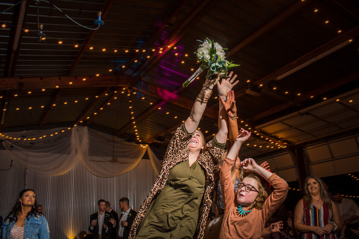  She wanted this bouquet so bad…  she took this kid out on the right of the frame.  My pictures are being held for insurance purposes.  I tease.  But seriously.  There was some hustle on that toss!   