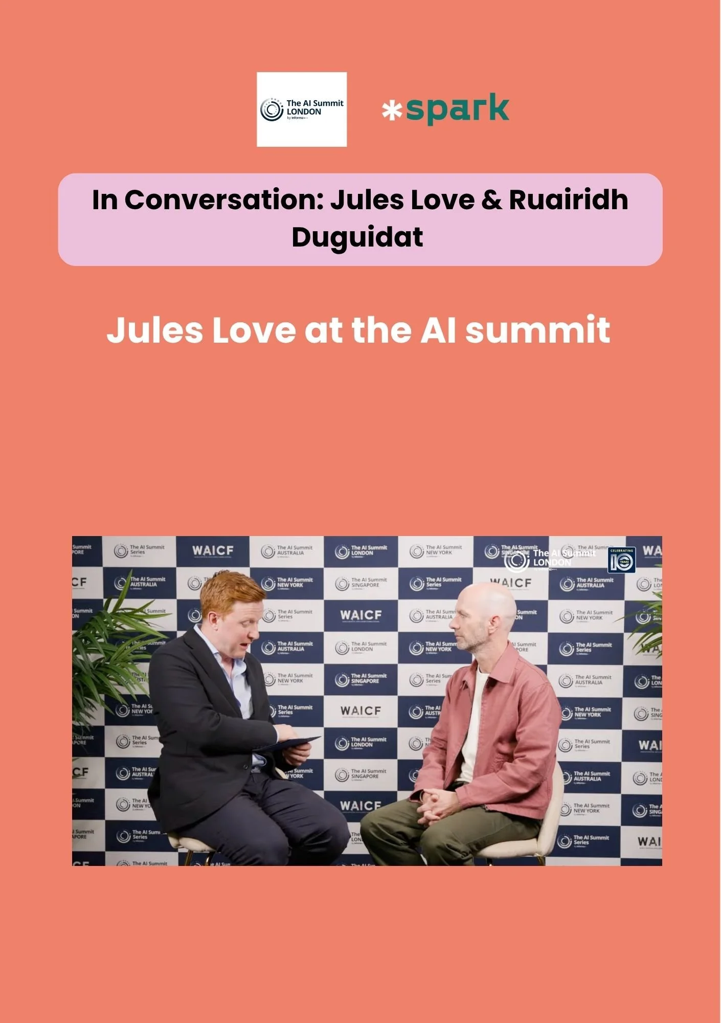 Two men in conversation at the AI summit, one with a tablet and the other with hands clasped, against a backdrop featuring event logos and branding.