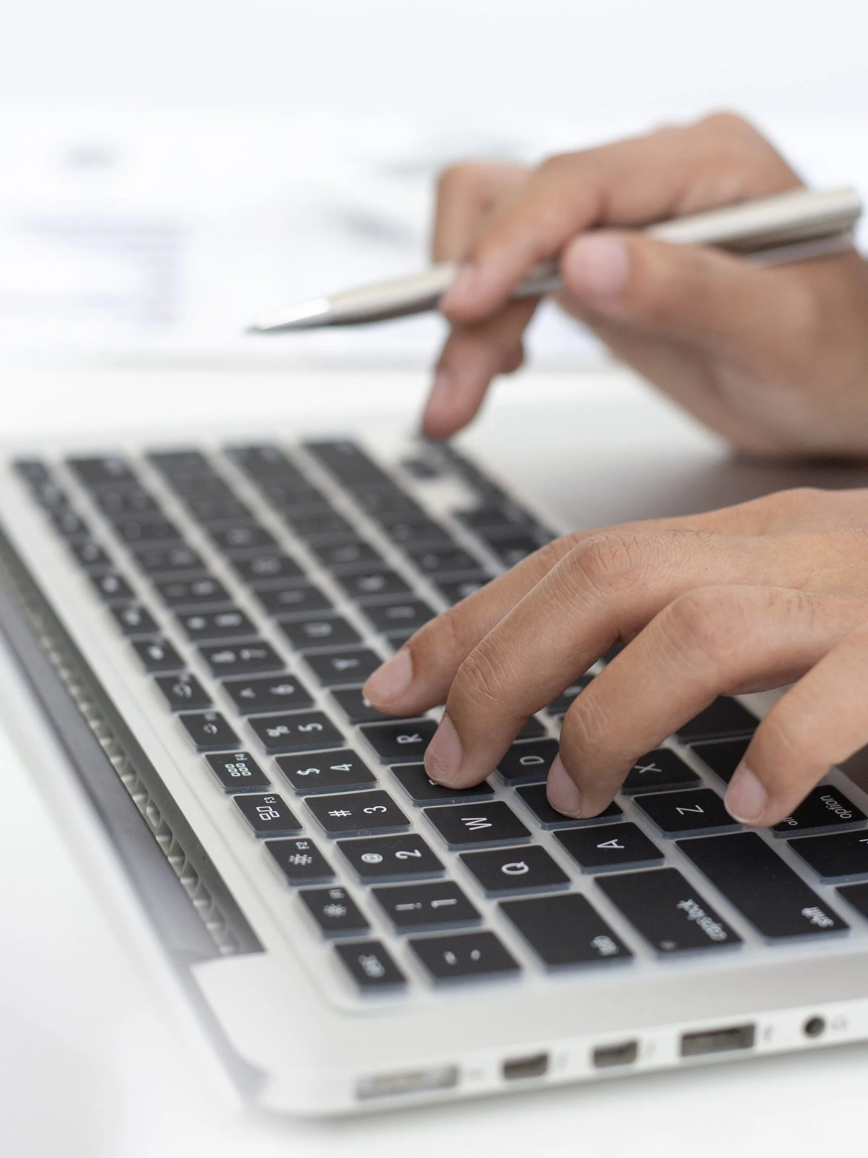 hands typing on a keyboard