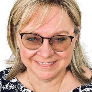 Headshot of a blonde middle-aged white woman in glasses.