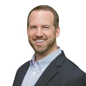 Headshot of a white middle-aged man with short brown hair and beard in a black blazer and light-colored collared shirt