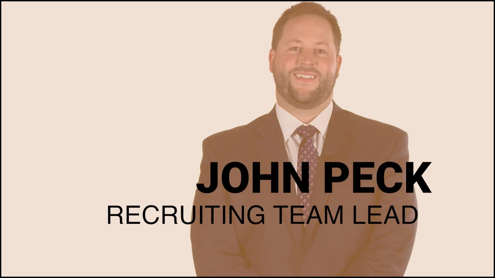 A man in a suit smiling with text overlay reading 'John Peck, Recruiting Team Lead'.