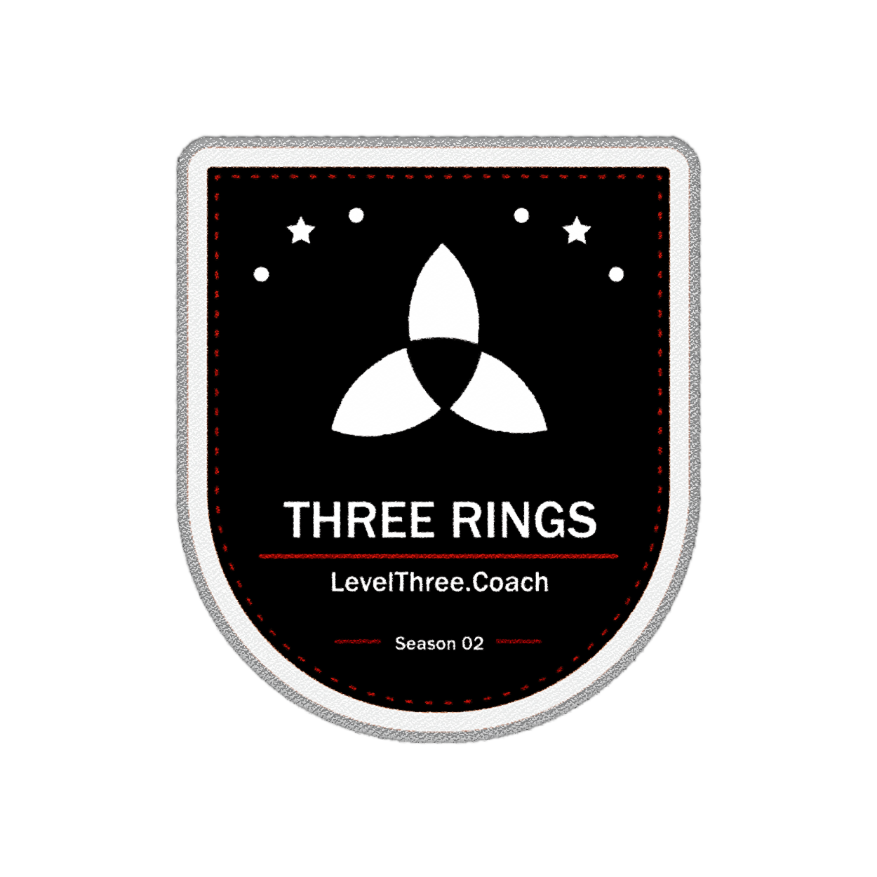 A badge featuring a black background with white and red design elements. It includes a white triple-ring symbol, the text 'THREE RINGS,' a website URL 'LevelThree.Coach,' and notes 'Season 02' at the bottom. There are also small stars and dots above the rings.