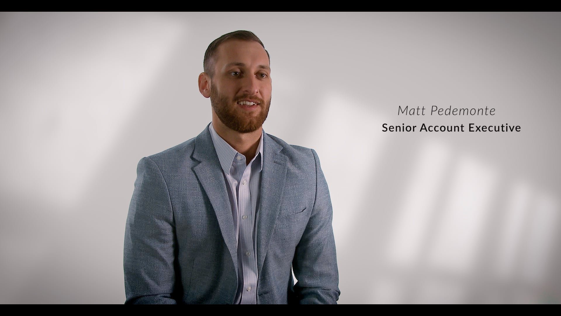 Professional man in a gray blazer and white shirt sitting against a plain background. Text on the right side reads 'Matt Pedemonte, Senior Account Executive.'