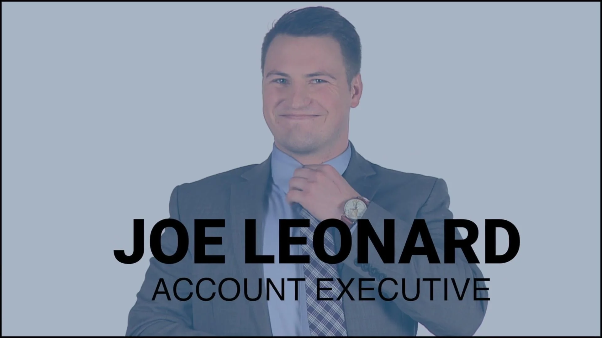 A man in a suit smiling with his hand adjusting his collar, text overlay reads 'Joe Leonard, Account Executive'.