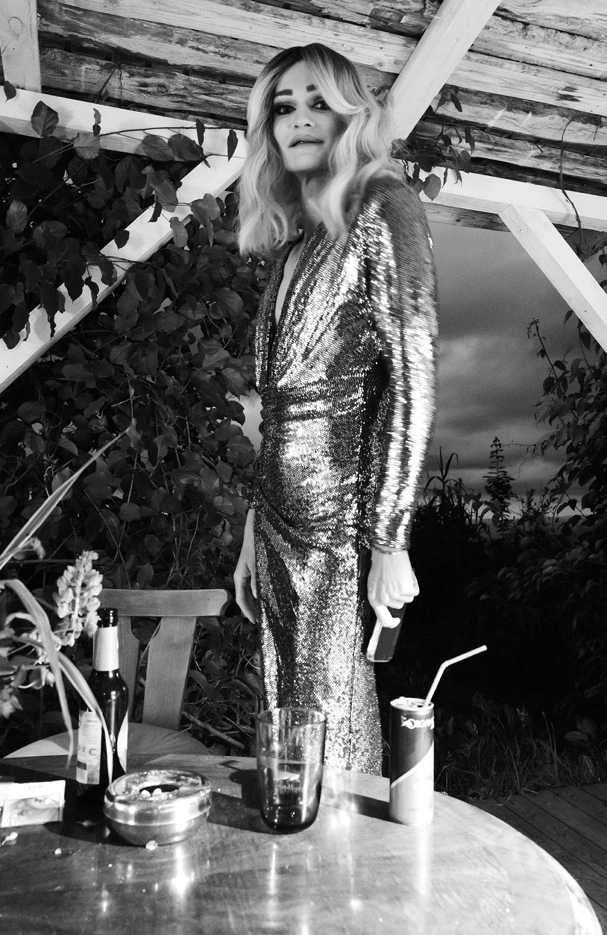 A portrait of Christoph Skoff in a stunning silver outfit as his drag persona Gloria Hole at the Austrian queer hotel.