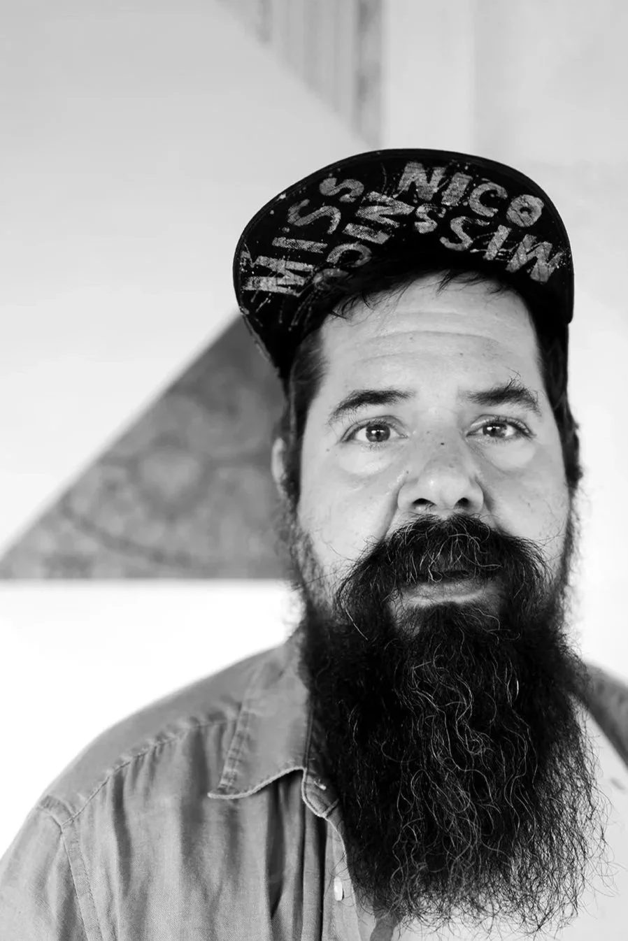 A portrait of Io Tondolo, non-binary artist and co-founder of the Austrian queer hotel Absteige Zur Bärtigen Therese.